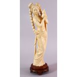 A FINE 19TH CENTURY CHINESE CARVED IVORY FIGURE OF A FEMALE, stood in an elegant pose holding a