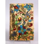 A 19TH CENTURY OR EARLIER ISLAMIC QAJAR POTTERY TILE, decorated with floral spray, 22cm x 15cm.