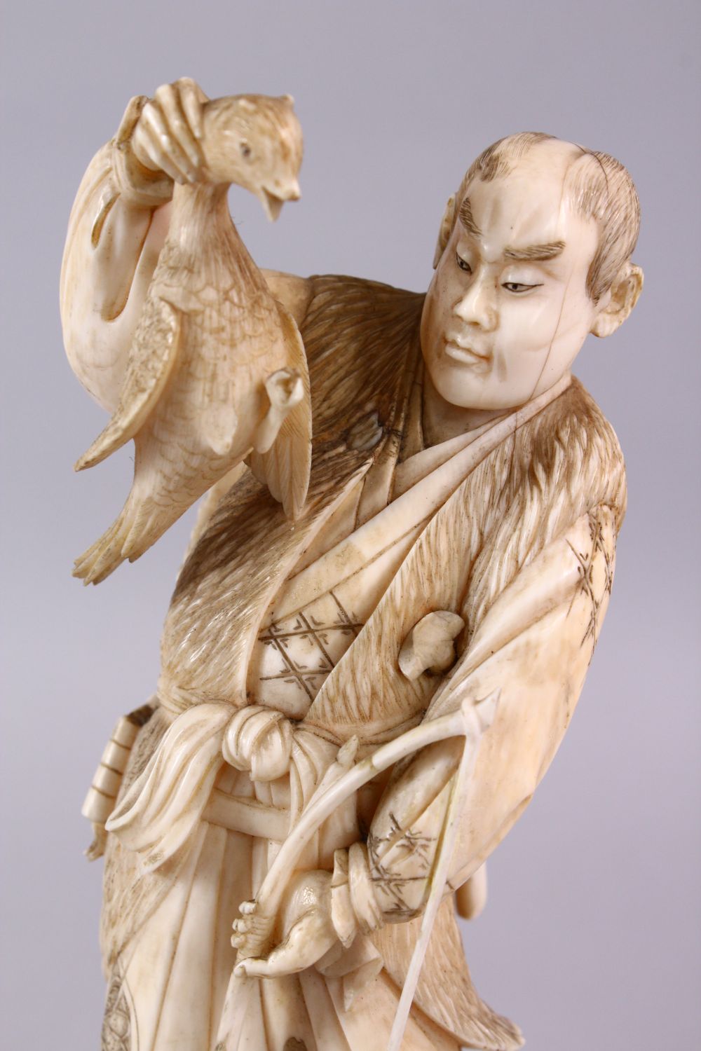 A FINE JAPANESE MEIJI PERIOD CARVED IVORY OKIMONO OF A HUNTSMAN, stood holding his catch with his - Image 5 of 6