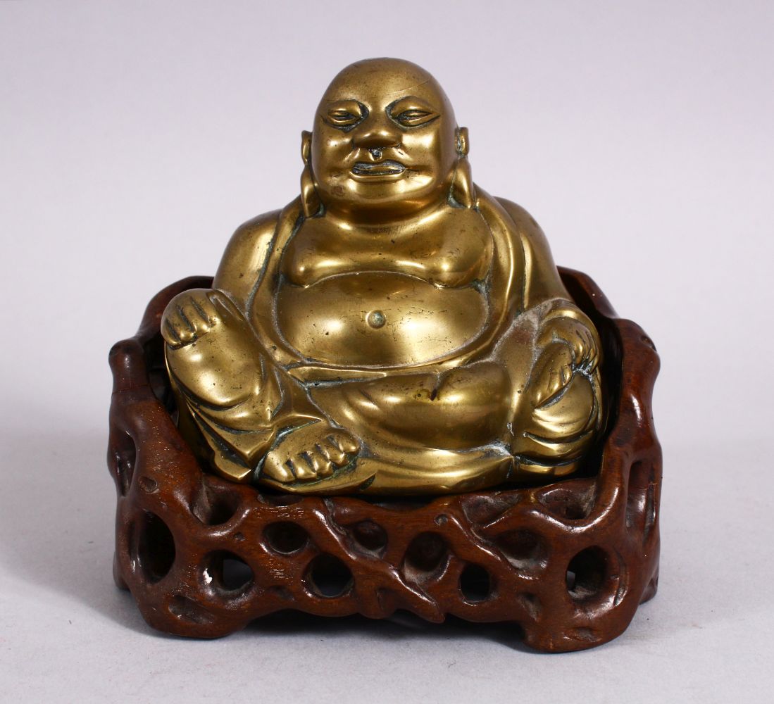 A 19TH CENTURY CHINESE BRONZE FIGURE OF BUDDHA & STAND, seated with his hand upon his knee, in a