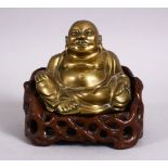 A 19TH CENTURY CHINESE BRONZE FIGURE OF BUDDHA & STAND, seated with his hand upon his knee, in a