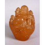 A CHINESE CARVED HARDSTONE FIGURE OF SEATED BUDDHA, in a seated position with boys 10cm