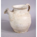 AN EARLY CHINESE POTTERY JUG, with floral decoration, 11cm high.