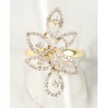 AN UNUSUAL YELLOW GOLD AND DIAMOND DRESS RING of flower form.