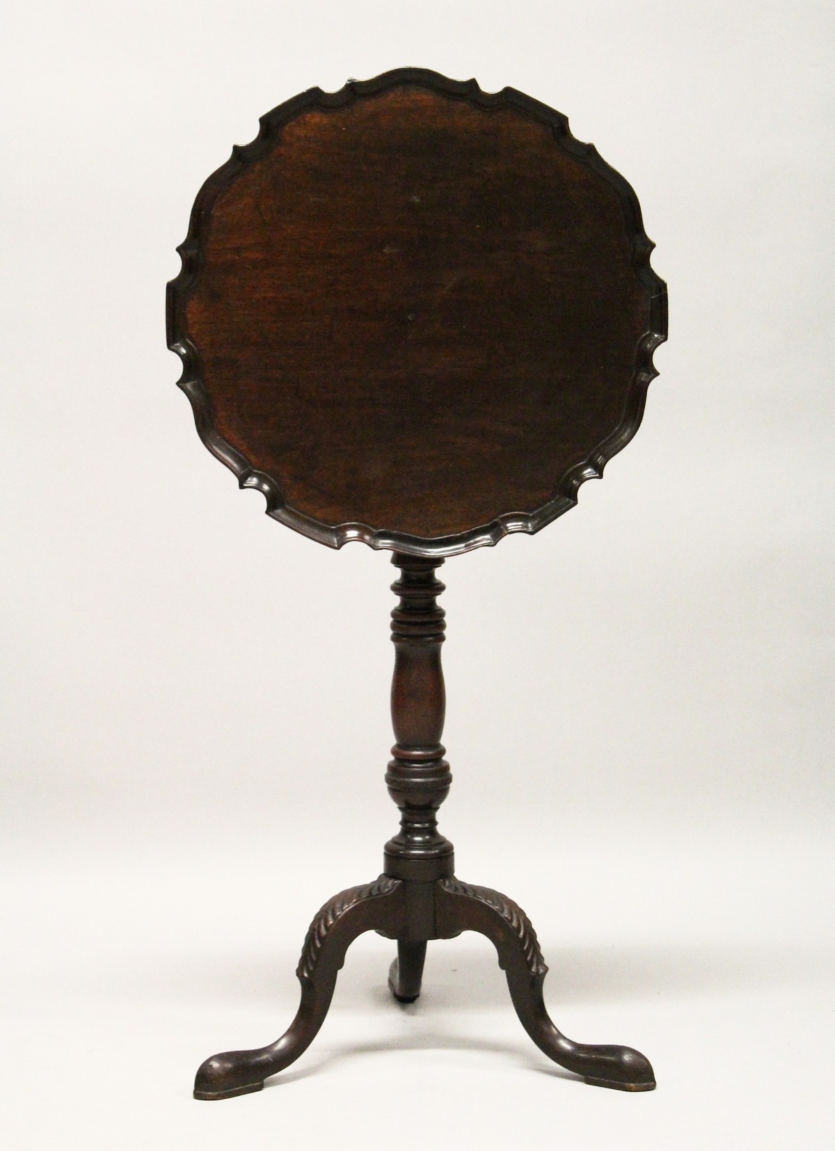 A GEORGE III DESIGN MAHOGANY TILT TOP TRIPOD TABLE, with piecrust circular top, turned column