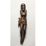 AN EARLY CARVED WOOD FIGURE OF CHRIST (lacking arms). 9ins high.