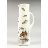 AN OPAQUE GLASS TAPERING JUG painted with fish. 12ins high.