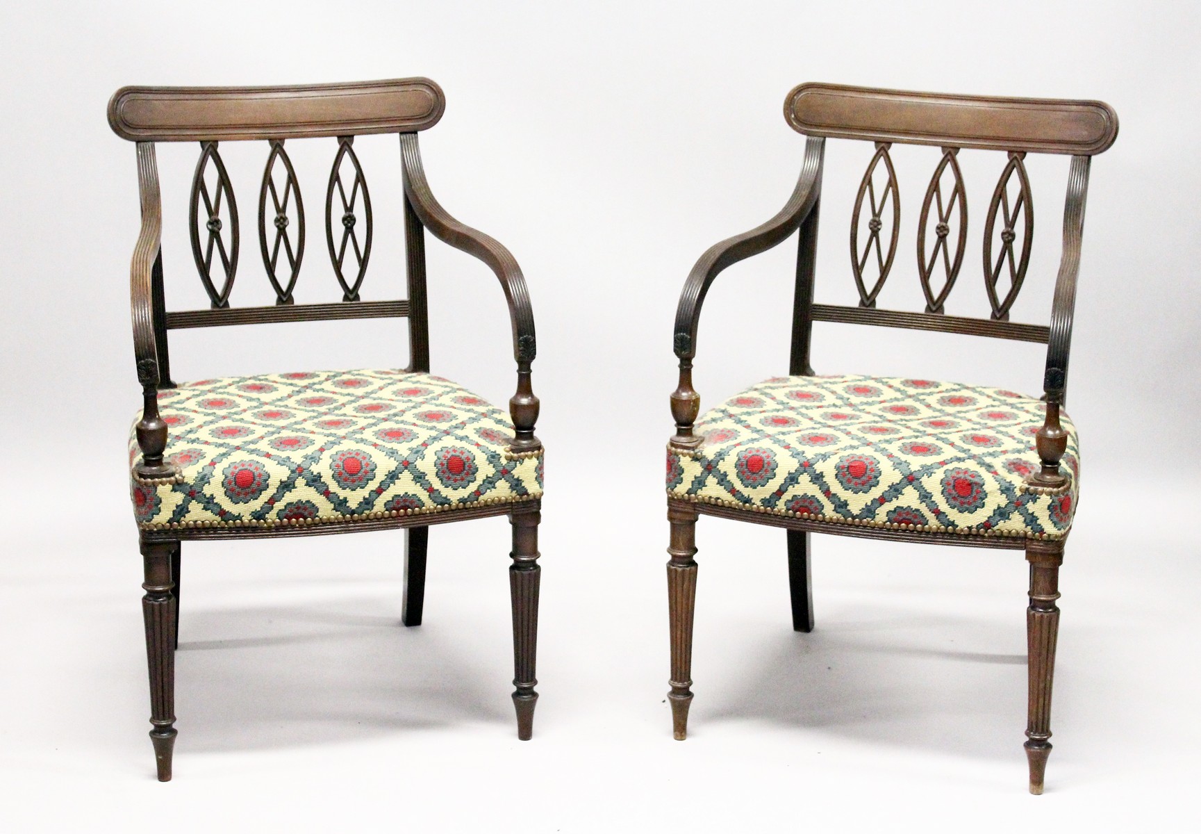 A GOOD PAIR OF REGENCY MAHOGANY ARMCHAIRS, with triple pierced oval splats, reeded arms, padded