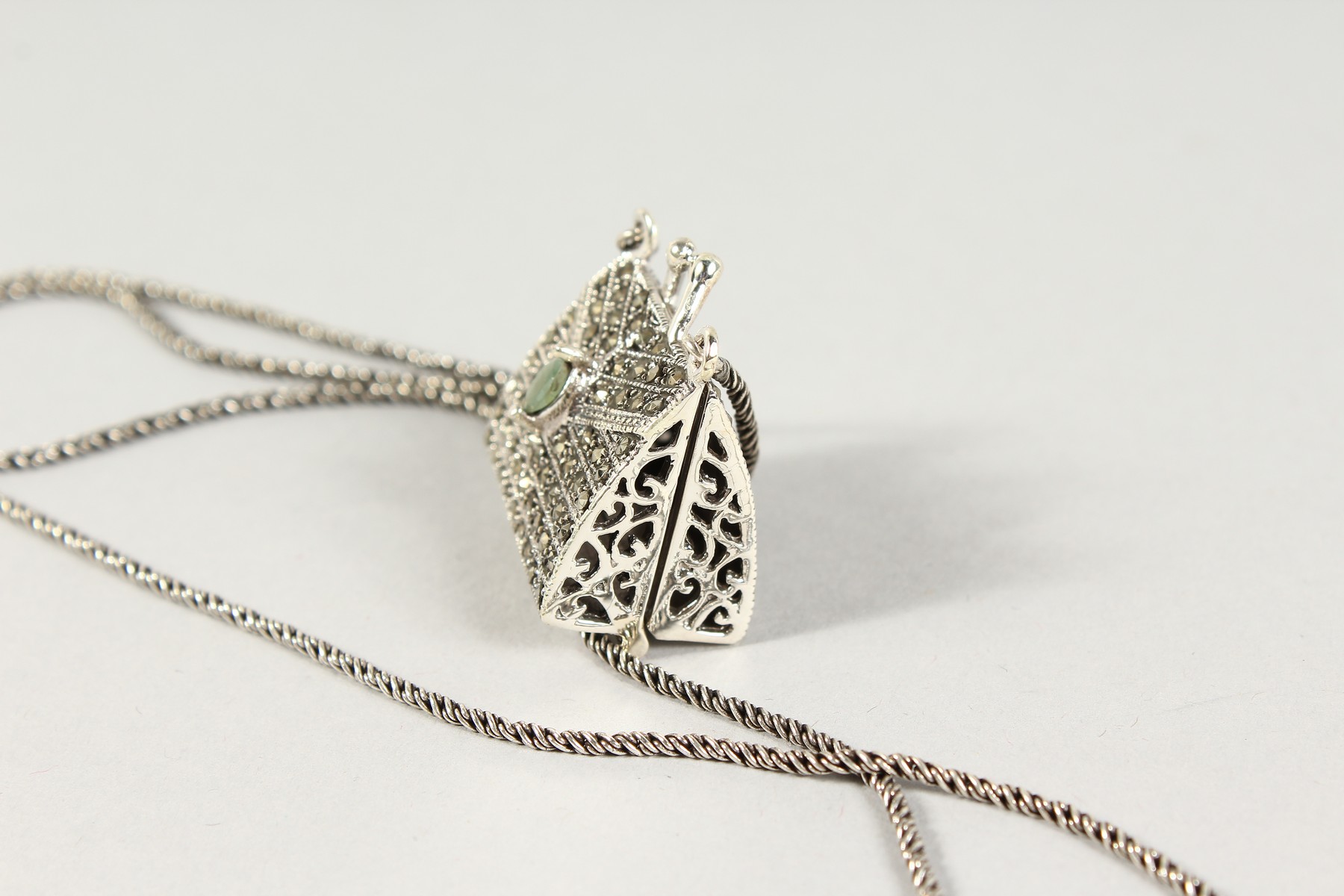 A SILVER, MARCASITE AND EMERALD SET HANDBAG PENDANT on a chain. - Image 2 of 2