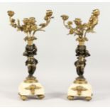 A VERY GOOD PAIR OF FRENCH GILT METAL AND BRONZE CUPID CANDELABRA. as cupids holding four