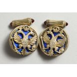A GOOD PAIR OF RUSSIAN SILVER AND BLUE ENAMEL CROWN AND EAGLE CUFFLINKS.