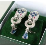 A PAIR OF SILVER AND SAPPHIRE SET PANTHER EARRINGS in the Cartier style.
