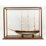 A MODEL OF A THREE MASTED SAILING SHIP, housed in a display case. Ship 27ins long.