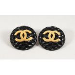 A PAIR OF CHANEL DOUBLE C GILT AND BLACK EARRINGS, in a Chanel box.