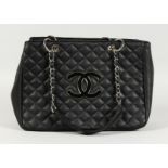 A CHANEL SOFT BLACK PADDED BAG with chrome and leather handles. 15ins wide.