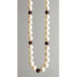 A STRING OF PEARLS WITH DIAMOND AND ENAMEL BEADS.