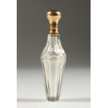 A GLASS GOLD TOP SCENT BOTTLE AND STOPPER. 11cms long.