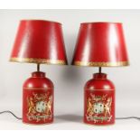 A LARGE PAIR OF RED TOLEWARE LAMPS AND SHADES.