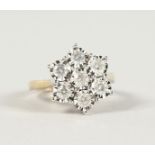 A SUPERB 9CT GOLD SEVEN STONE DAISY CLUSTER RING.