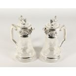 A GOOD PAIR OF GLASS AND SILVER PLATE CLARET JUGS, engraved with fruiting vines. 11ins high.
