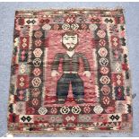 AN UNUSUAL SMALL FLATWEAVE KELIM RUG, the central panel depicting a standing male figure. 3ft 4ins x