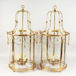 A GOOD LARGE PAIR OF BRASS AND GLASS CIRCULAR LANTERNS.