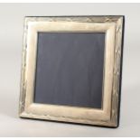 A SQUARE PHOTOGRAPH FRAME with crossbanded border. 6.5ins x 6.5ins.
