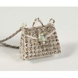 A SILVER, MARCASITE AND EMERALD SET HANDBAG PENDANT on a chain.