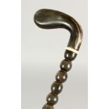 A 19TH CENTURY BOBBIN TURNED WALKING STICK with RHINO HANDLE. 35ins long.