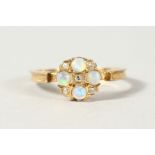 A 9CT GOLD, DIAMOND AND OPAL CLUSTER RING.