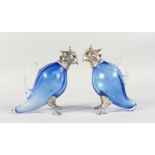 A PAIR OF NOVELTY BLUE GLASS CLARET JUGS, modelled as parrots, with plated mounts. 6.5ins high.