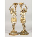 A PAIR OF SPELTER FIGURAL CANDLESTICKS, 20TH CENTURY, modelled as an Egyptian man and woman