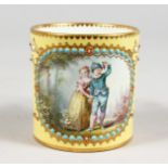 A GOOD SEVRES YELLOW GROUND CAN painted with panel of a boy and girl with turquoise bead decoration.