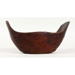 A CARVED WOOD FOOD BOWL, possibly Maori. 9ins long.