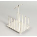 A CHRISTOPHER DRESSER DESIGN FOUR-DIVISION TOAST RACK.