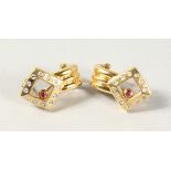 A PAIR OF 18CT YELLOW GOLD CHOPARD STYLE DANCING RUBY AND DIAMOND EARRINGS.