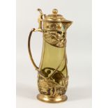 AN ART NOUVEAU LIDDED JUG with green tinted glass body and naturalistic gilt metal mounts. 14ins