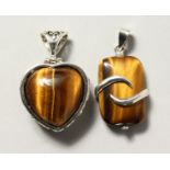 TWO SILVER AND TIGER'S EYE PENDANTS.