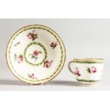 A SEVRES COFFEE CUP AND SAUCER painted with roses between husk borders, gilder's mark for