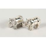 TWO CAST SILVER HIPPO AND RHINO FIGURES.