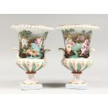 A PAIR OF CAPODIMONTE TWO-HANDLED URNS, with nude figures bathing in relief, on square bases. N mark