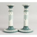 A PAIR OF CARLTON WARE JASPER CIRCULAR CANDLESTICKS on circular bases. Printed mark. 7.5ins high.