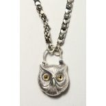 A SILVER OWL PADLOCK PENDANT on a chain.