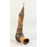 A TRIBAL CARVED AND STAINED BONE FIGURAL PIPE. 13.5ins long.