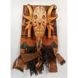 A NORTH AMERICAN INDIAN PAINTED LEATHER COVER, and a painted carved wood mask (2). Leather 30ins x