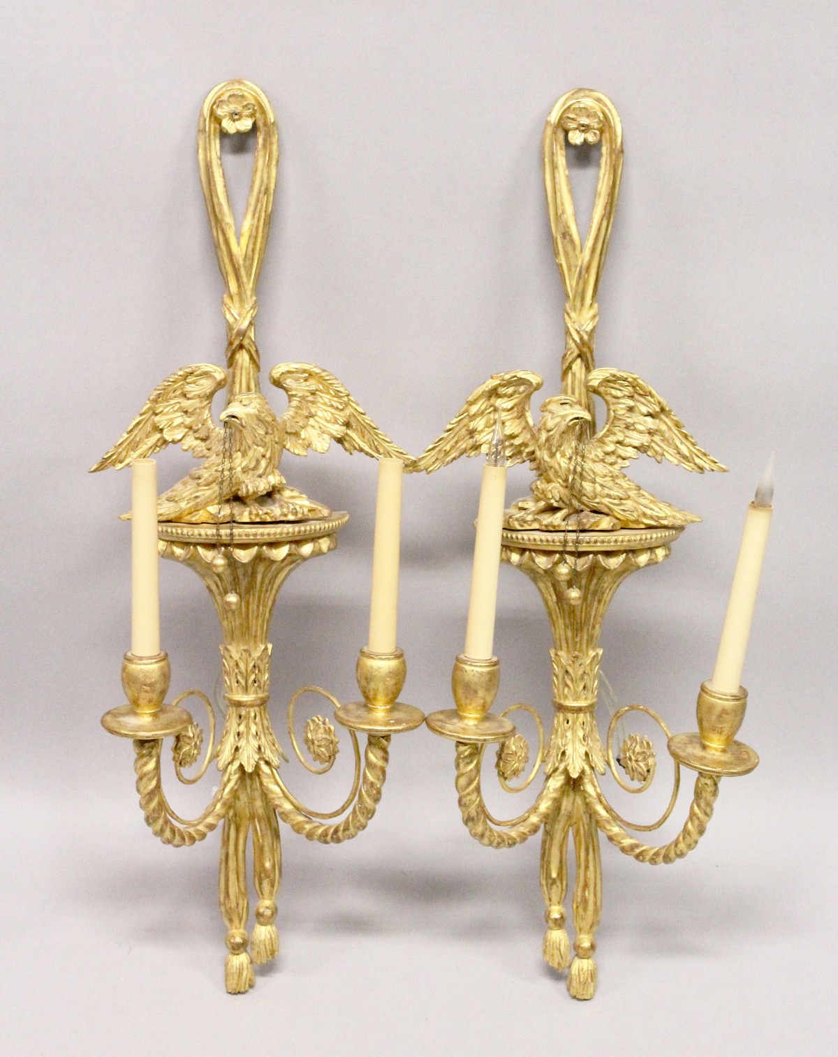 A GOOD PAIR OF REGENCY DESIGN CARVED, GILTWOOD TWIN-BRANCH WALL APPLIQUES, with eagle mounts. 2ft