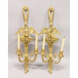 A GOOD PAIR OF REGENCY DESIGN CARVED, GILTWOOD TWIN-BRANCH WALL APPLIQUES, with eagle mounts. 2ft