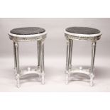 A PAIR OF OVAL SILVERED WOOD TABLES with marble tops.