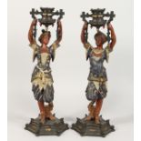 A PAIR OF SPELTER FIGURAL CANDLESTICKS, 20TH CENTURY, modelled as a Turkish man and woman holding