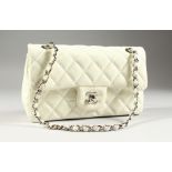 A CHANEL SOFT WHITE PADDED BAG with chrome and leather handles. 9.5ins wide, in a black Chanel bag.